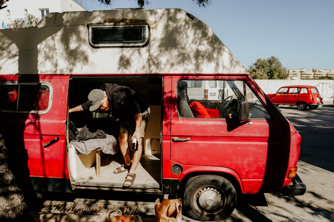 man standing inside van during daytime