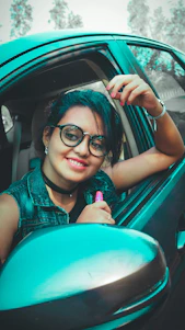 A friendly customer handing car keys to a smiling driver in a bright green rental car.