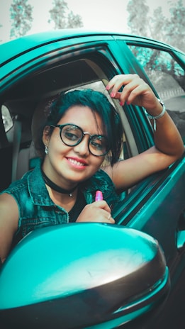 Smiling customer standing next to their car with a freshly replaced windshield.