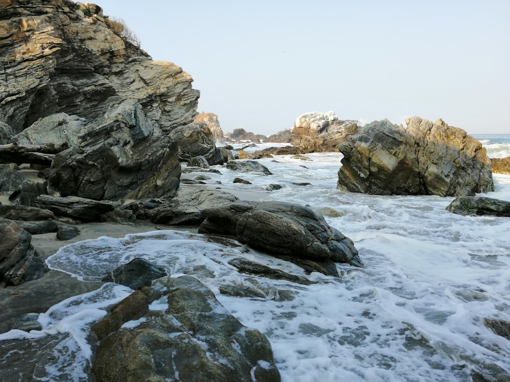water waves on brown rocks