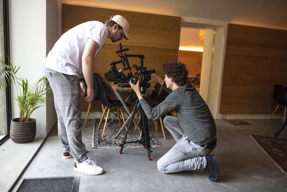 two men setting up camera in room