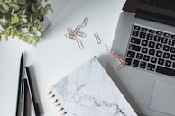An elegant workspace with colorful stationery and plants.