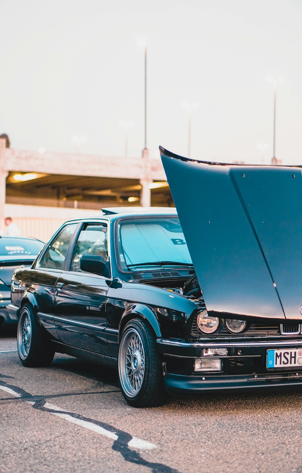 opened front-hood of black coupe