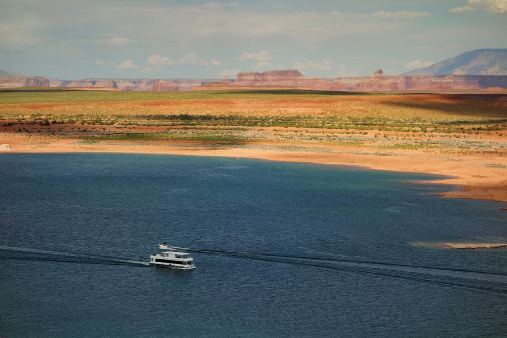 white yacht on body of water