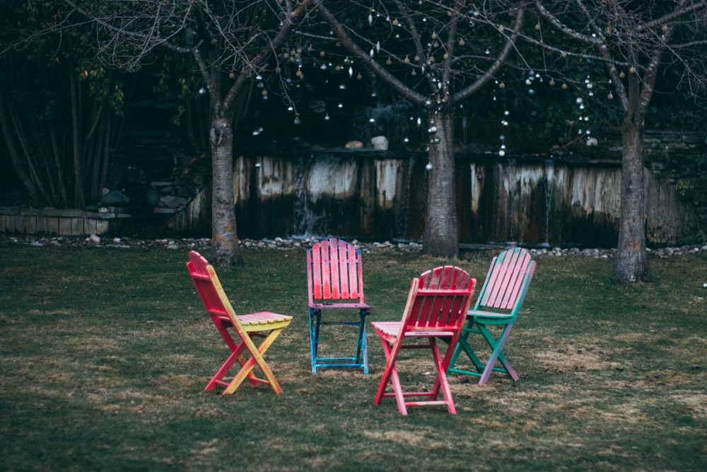 four assorted-color wooden chairs