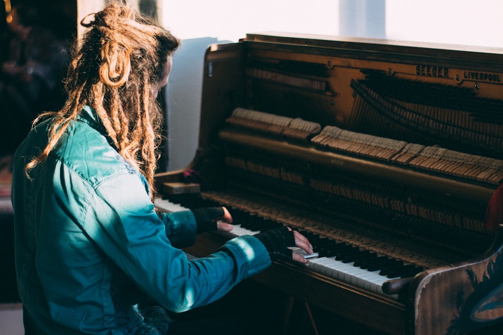 man playing piano at daytime