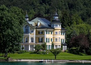 beige and white painted house surrounded with trees