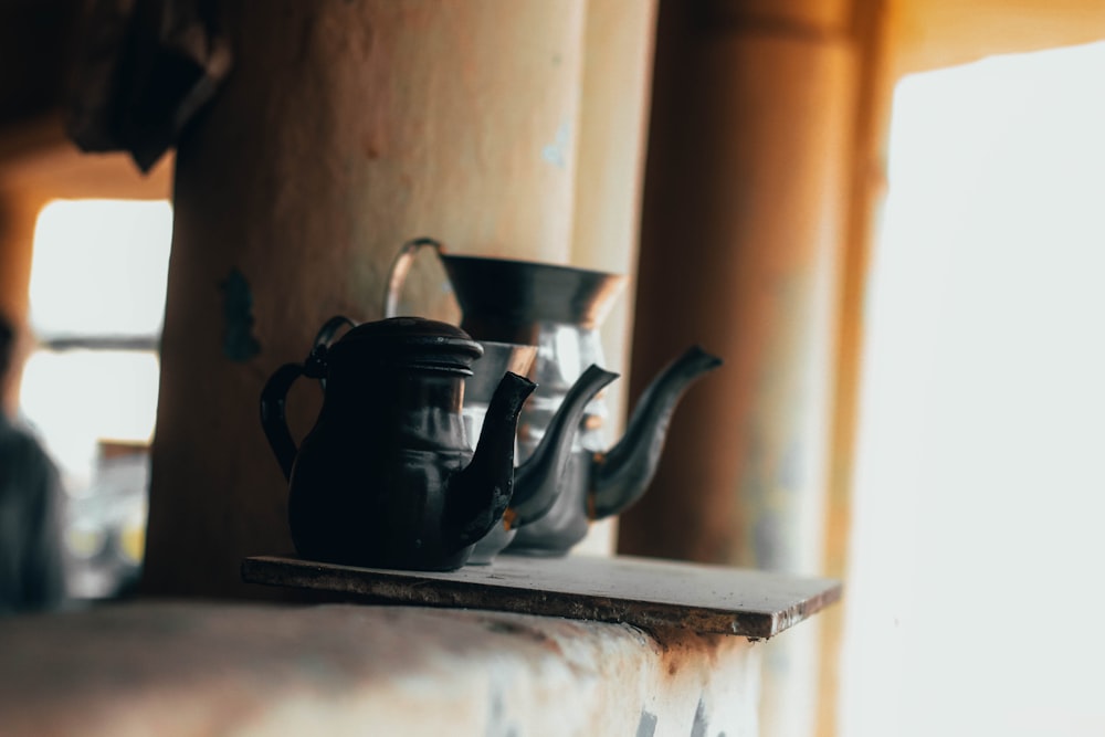 three black teapots