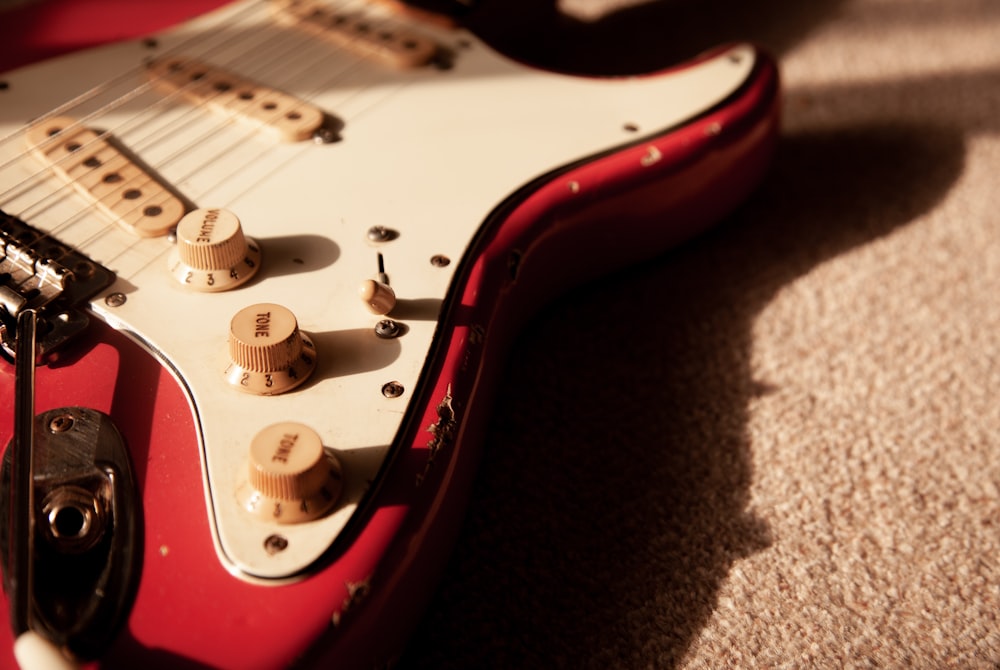 white and red electric guitar