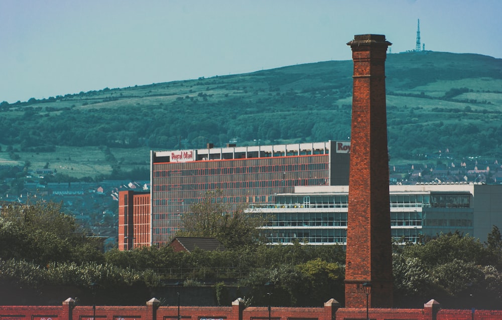 brown brick tower across brown and white building