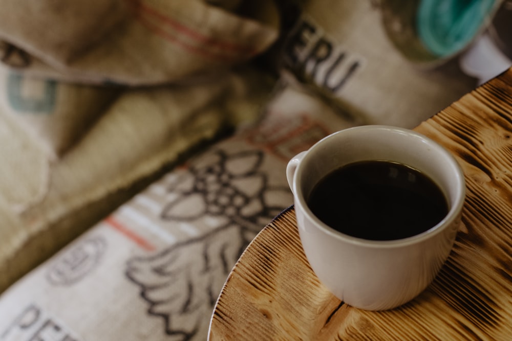 white ceramic mug on brown wooden table