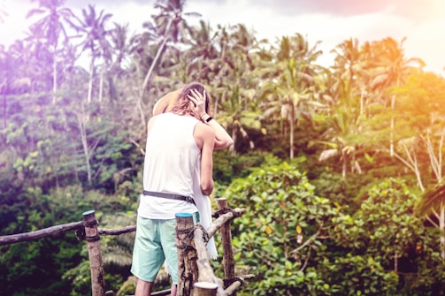 A couple enjoying a private dinner overlooking a lush tropical rainforest.