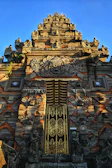 Close-up of the temple's intricately carved entrance with traditional decorations.
