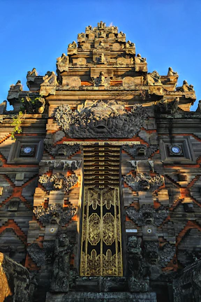 Close-up of the temple's intricately carved entrance with traditional decorations.