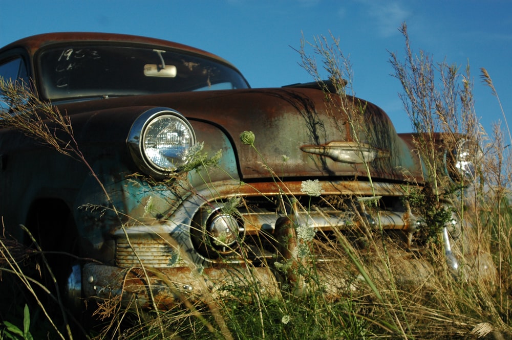 classic teal car on grass field