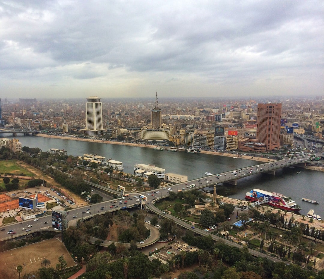 ferries along the city river banks near bridge with crossing cars,