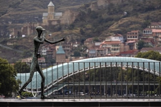 man statue beside fence