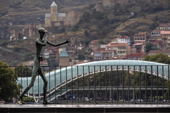 man statue beside fence
