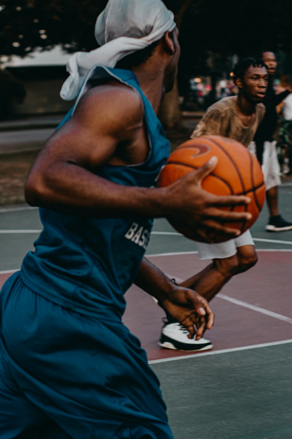 man in blue basketball uniform with ball in court