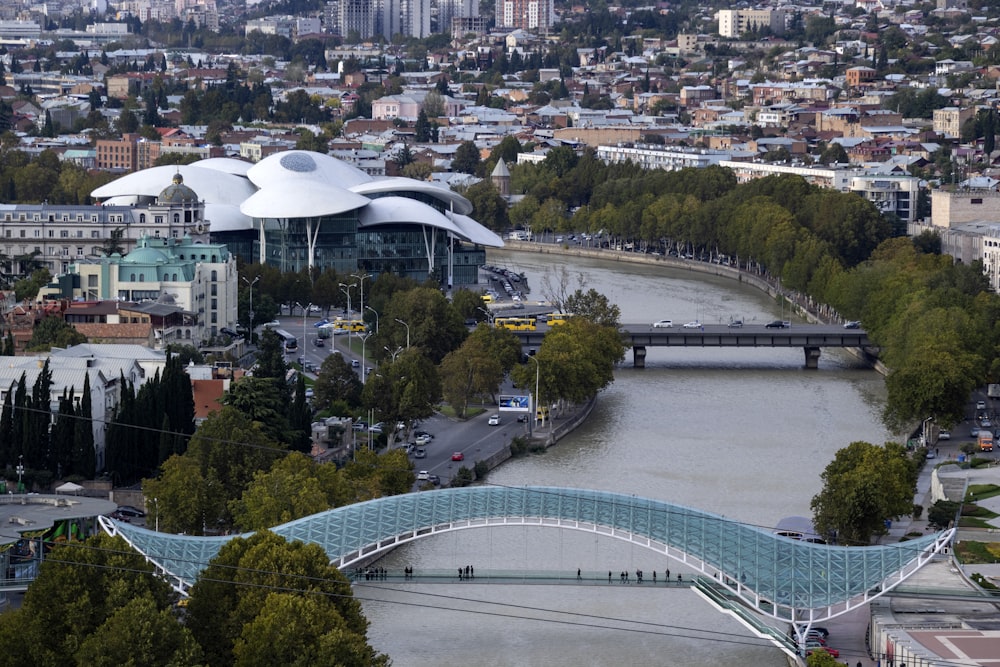 glass roofed steel beam bridge on city river