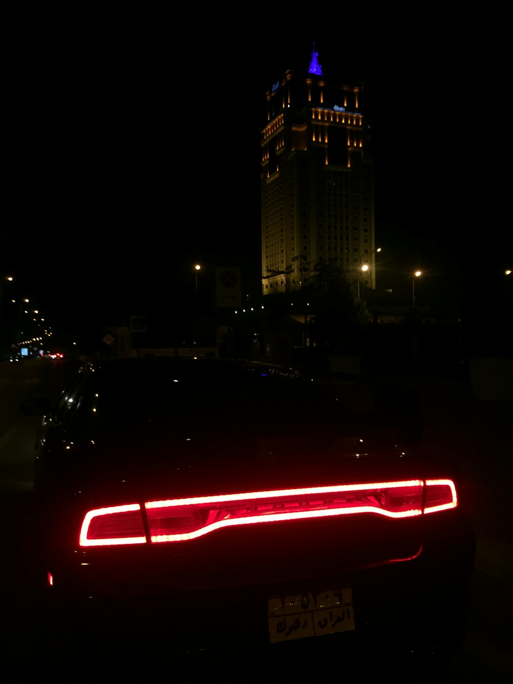 black Dodge Charger with taillights on