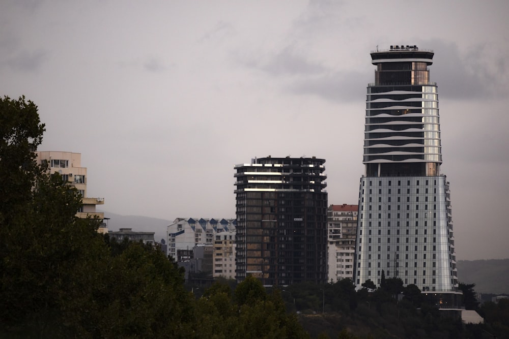 high-rise buildings under grey cloudy sky