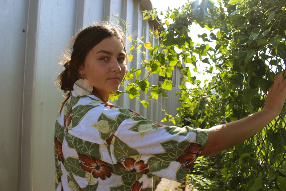 woman in white and green floral top