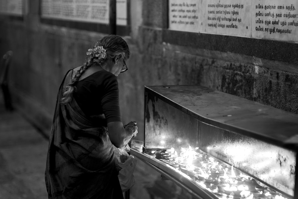 a woman in a black and white photo looking at something