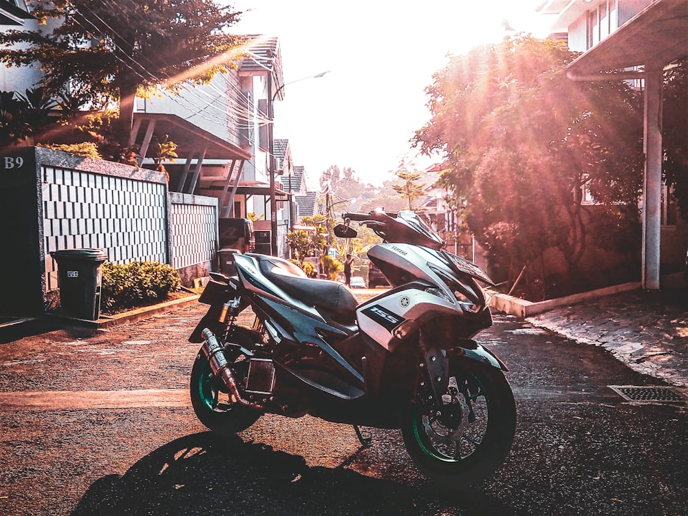 parked gray Yamaha motor scooter on road