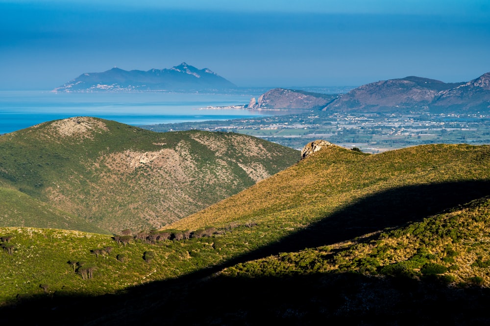 green mountains near ocean