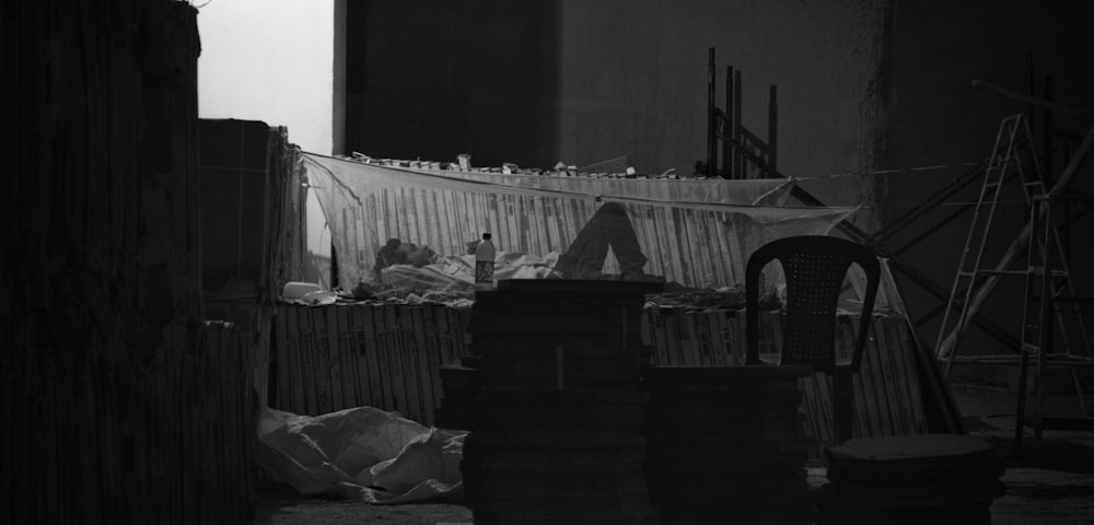 grayscale photography of person lying in bed with mosquito net