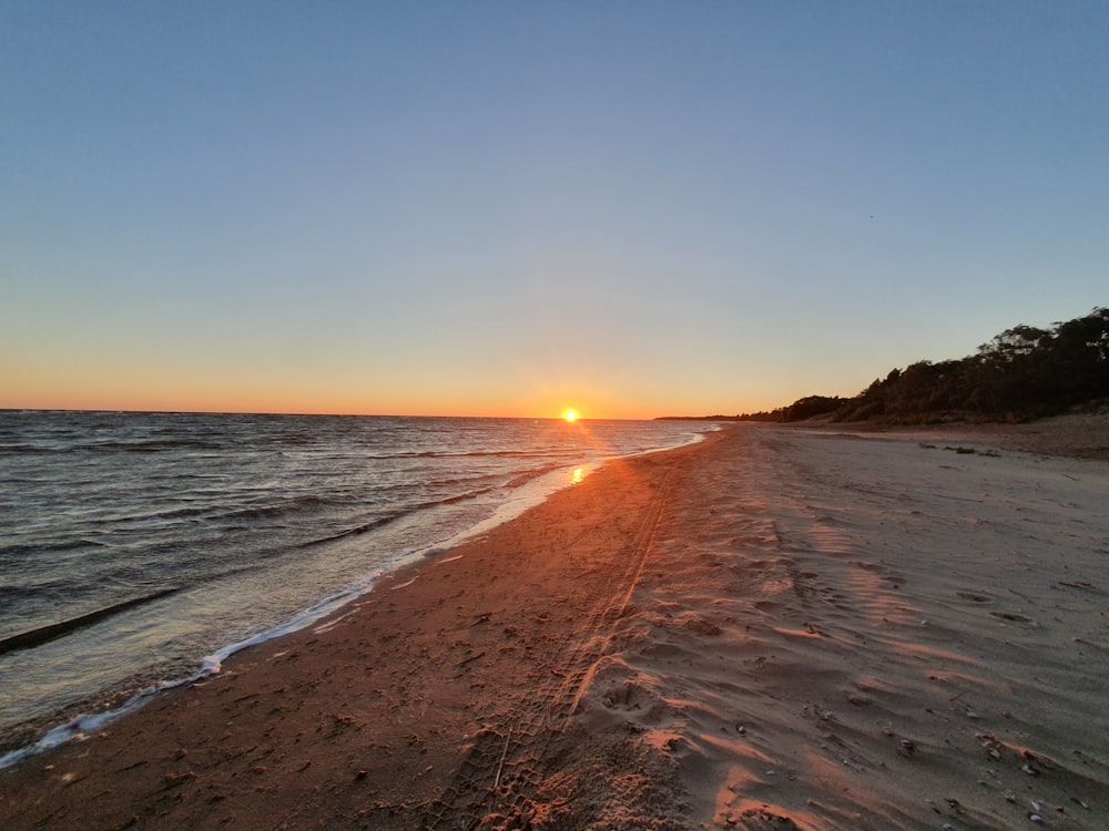 landscape photo of a beach at sunset