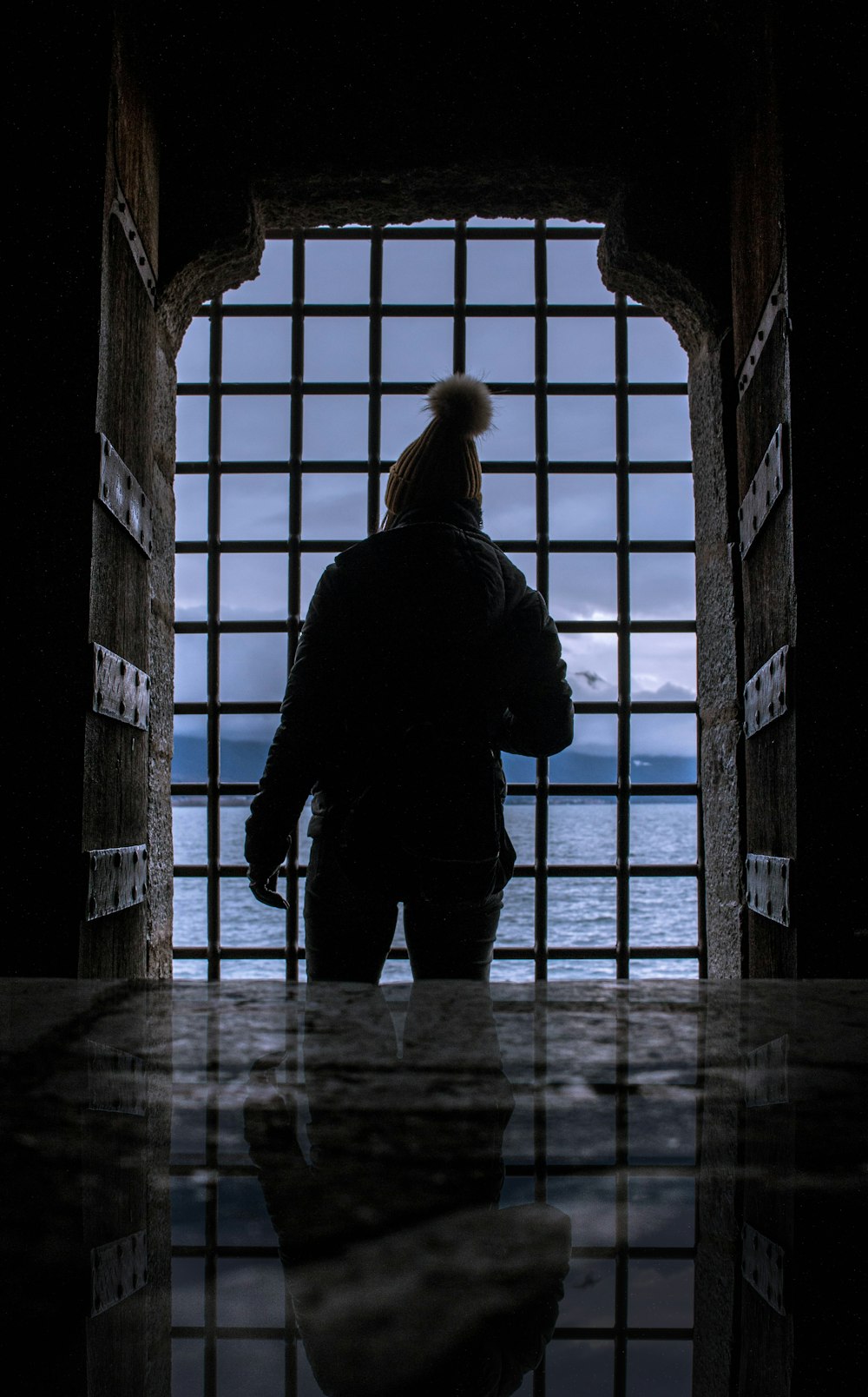 silhouette of person standing near gate