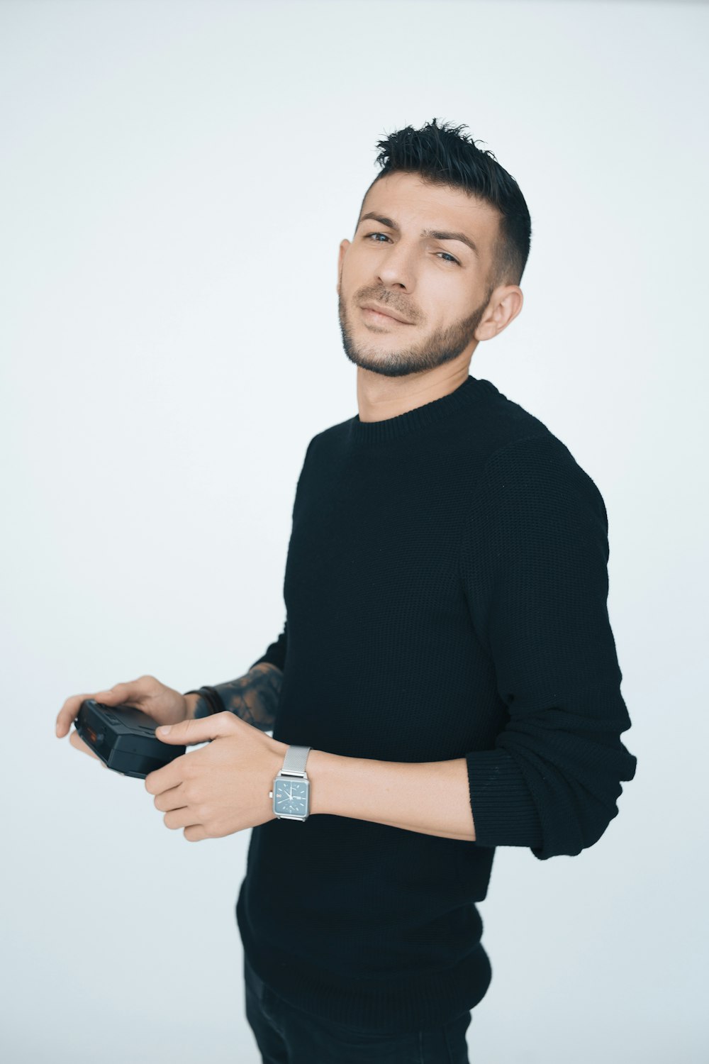 man in black sweater standing on focus photography