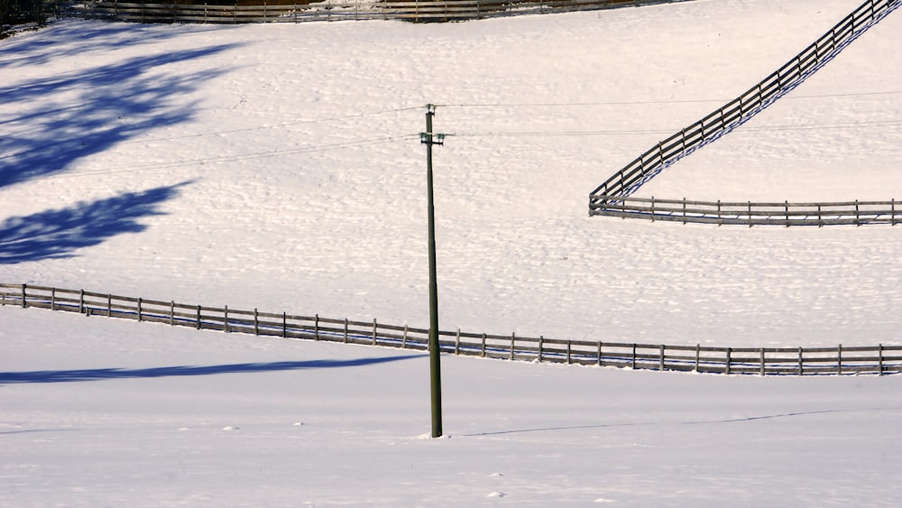 a man riding a snowboard down a snow covered slope