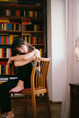 A calming illustration of a person sitting comfortably in a cozy room, engaging in a therapy session.