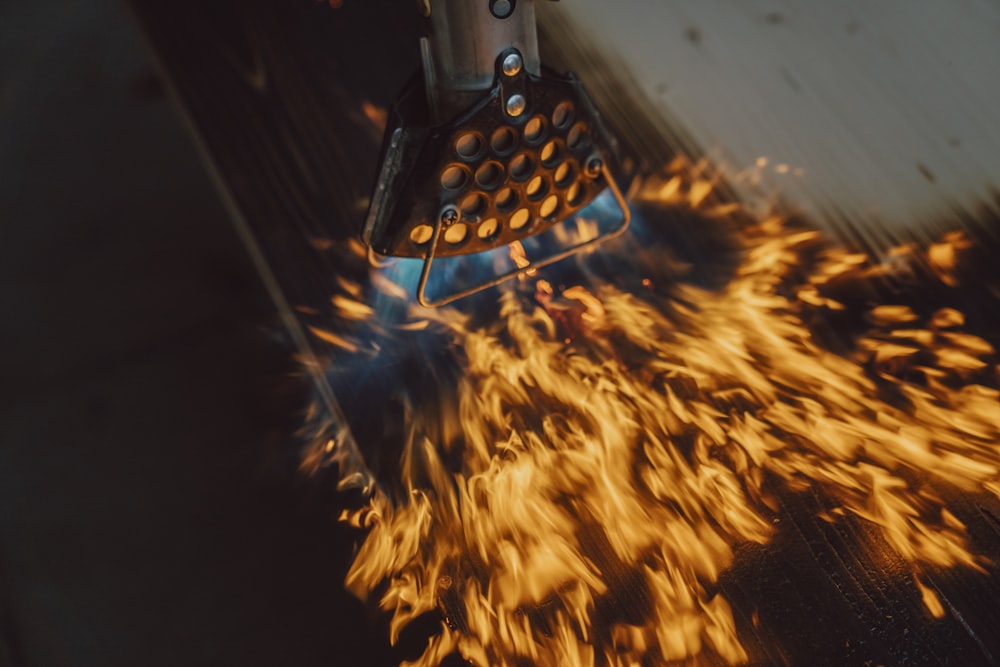 a close up of a metal object with fire coming out of it