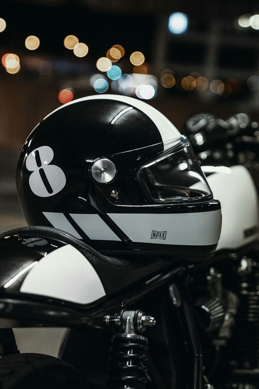 white and black helmet on motorcycle