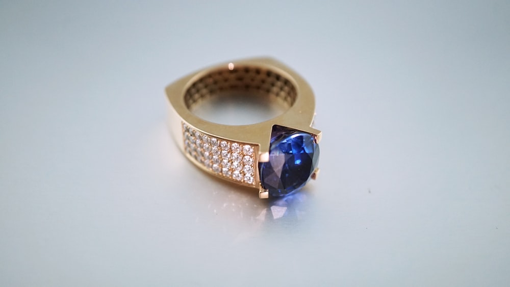 gold-colored and blue gemstone ring