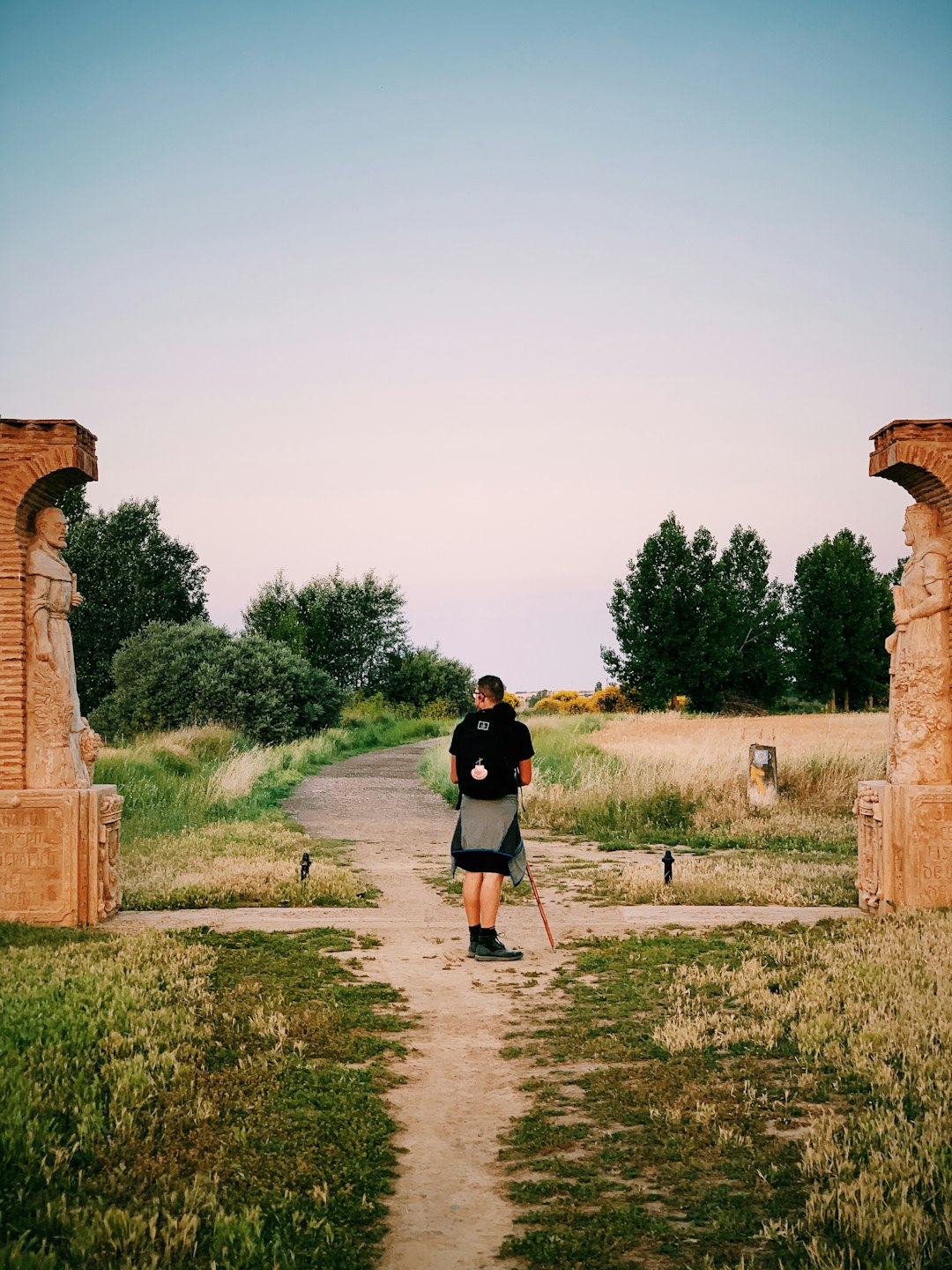 person standing on crossroad near brown ruins