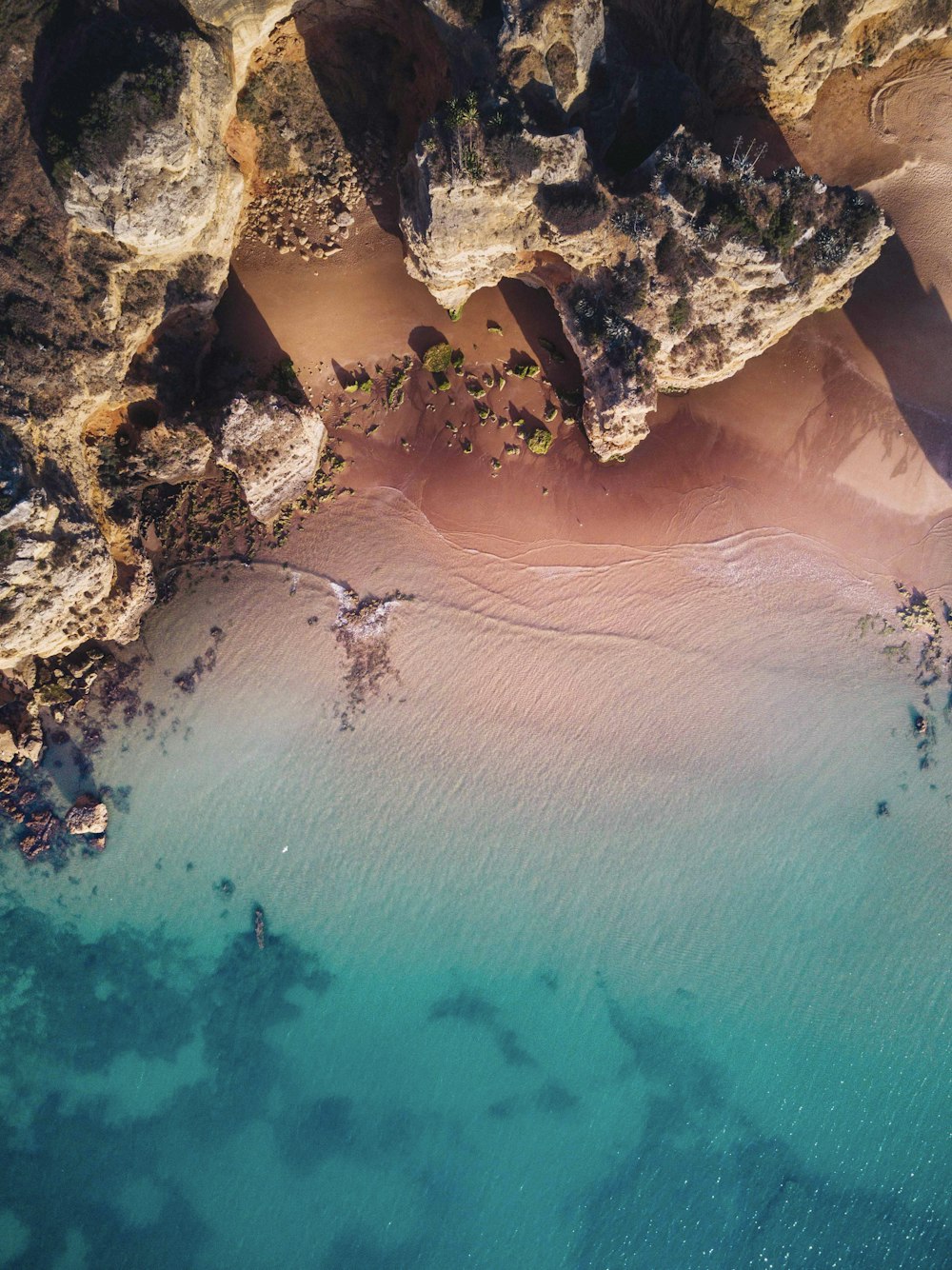 brown rock formation near beach