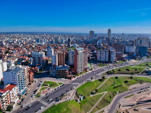 A vibrant commercial district with office towers and bustling streets during daytime.