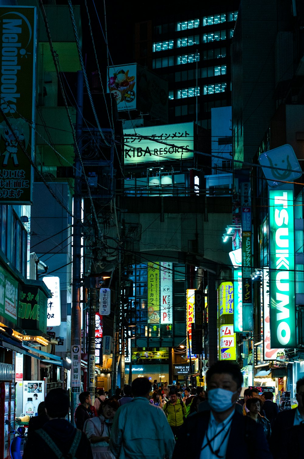 people gathering near street between building during nighttime