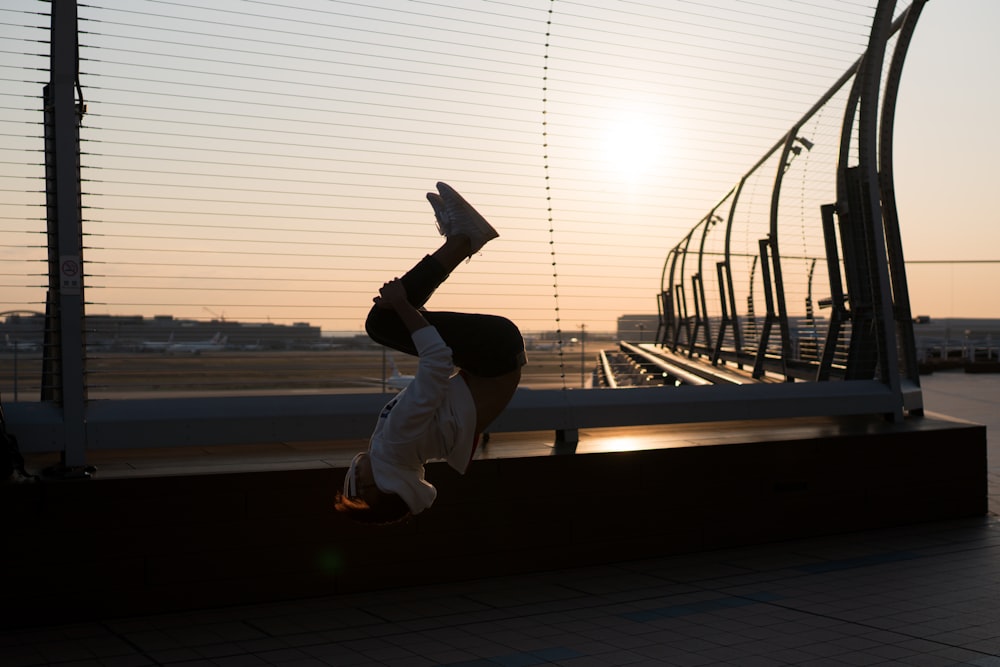 photography of person doing back tambling during daytime