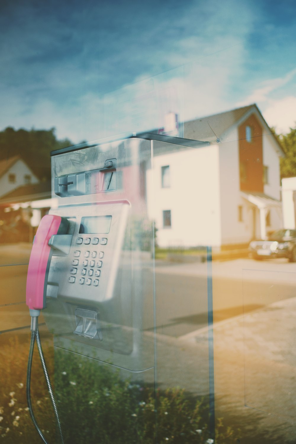 white and pink telephone booth