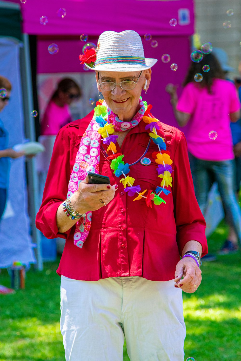 smiling woman with smartphone in park