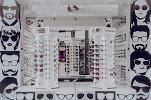 Trendy sunglasses displayed on a sleek white stand against a bright, airy background.