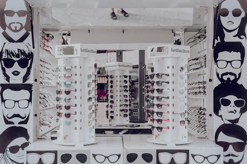 Trendy sunglasses displayed on a sleek white stand against a bright, airy background.