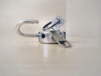 A friendly locksmith in blue uniform unlocking a door with professional tools.