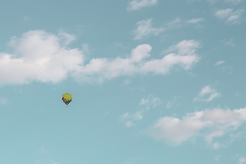 yellow hot air balloon on mid air